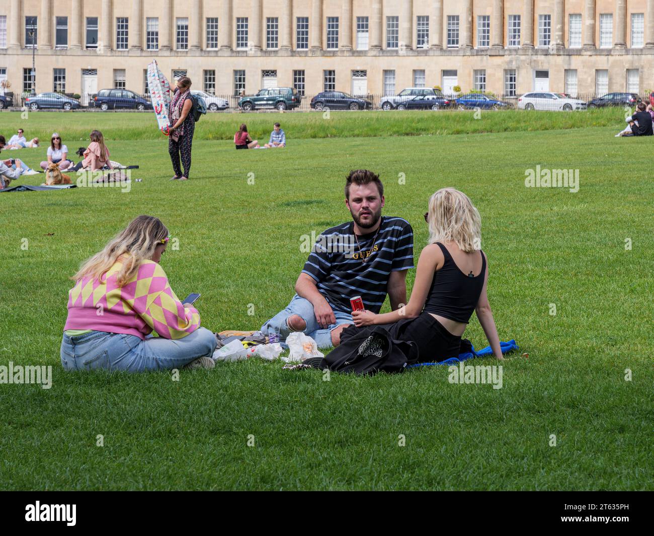 people enjoying the sunshine by the royal Crescent, Bath, Somerset, England, UK Stock Photo