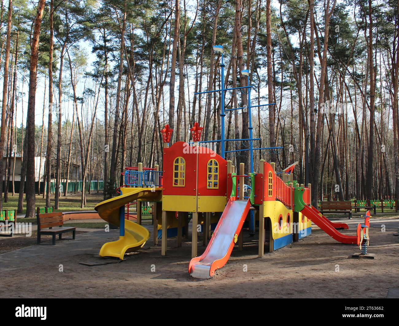 Empty open air colored play park with straight and spiral slides for children Stock Photo