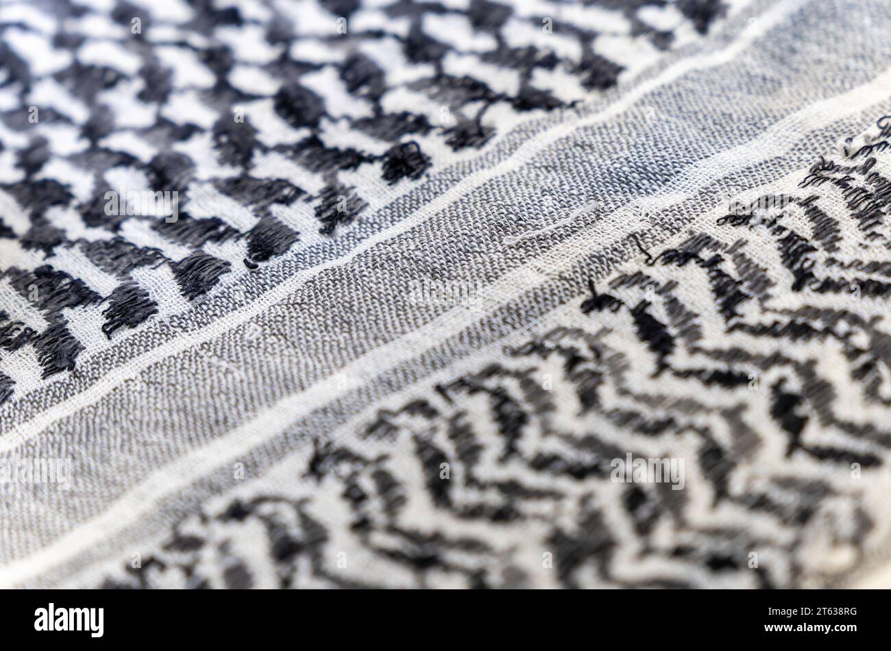 close-up of a Palestinian headscarf or kufiya. The traditional black and white headscarf of the Arab man (Keffiyeh). The weave forms a diagonal path Stock Photo