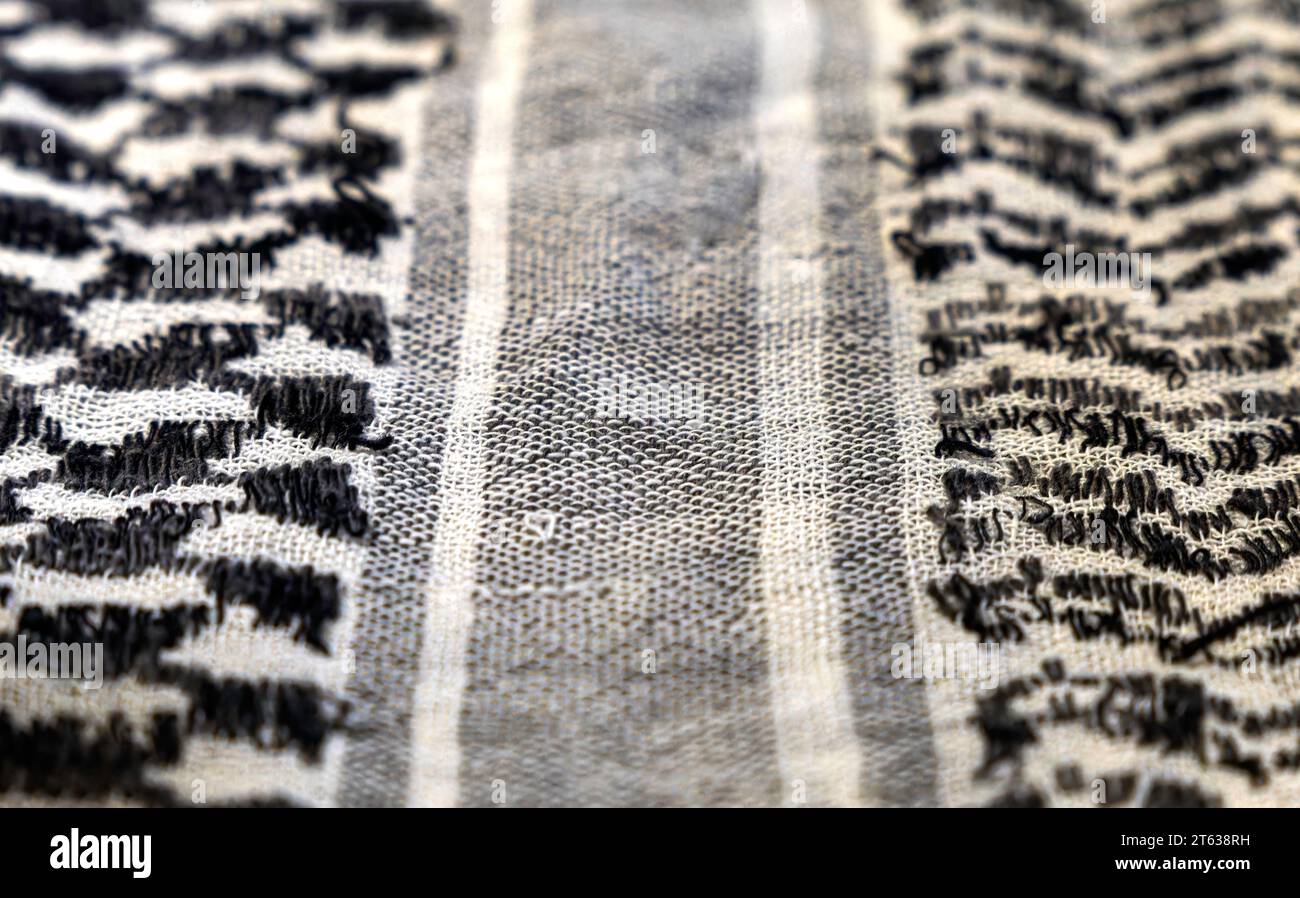 close-up of a Palestinian headscarf or kufiya. The traditional black and white headscarf of the Arab man (Keffiyeh). The weave forms a central path Stock Photo