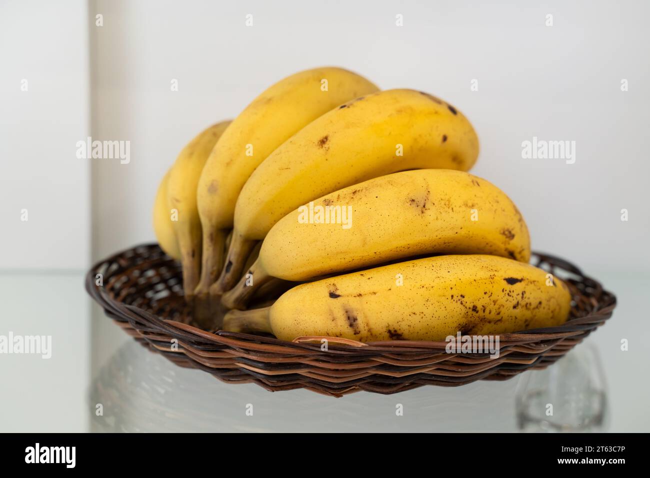 A bunch of fresh banana lie on the table in a modern kitchen, healthy life concept. Stock Photo