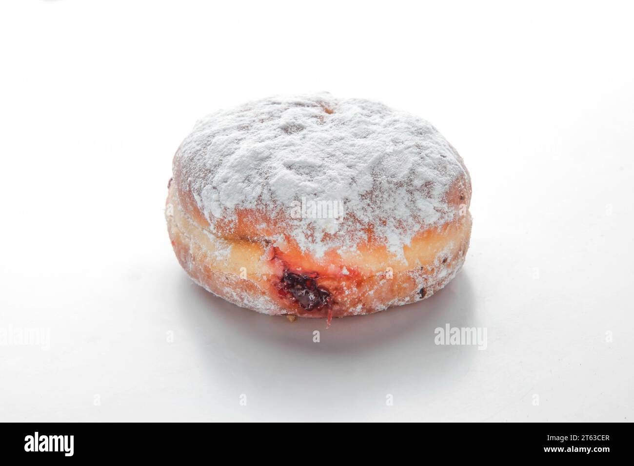 Strawberry filled jam brioche doughnut. Stock Photo