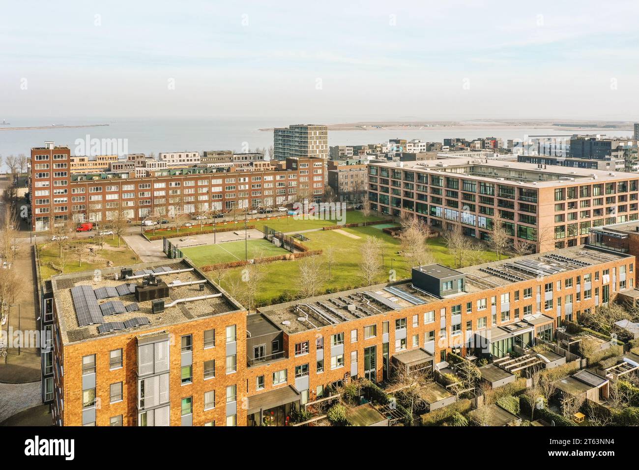 View of Aerial view of apartment buildings with solar panels on rooftop and ...