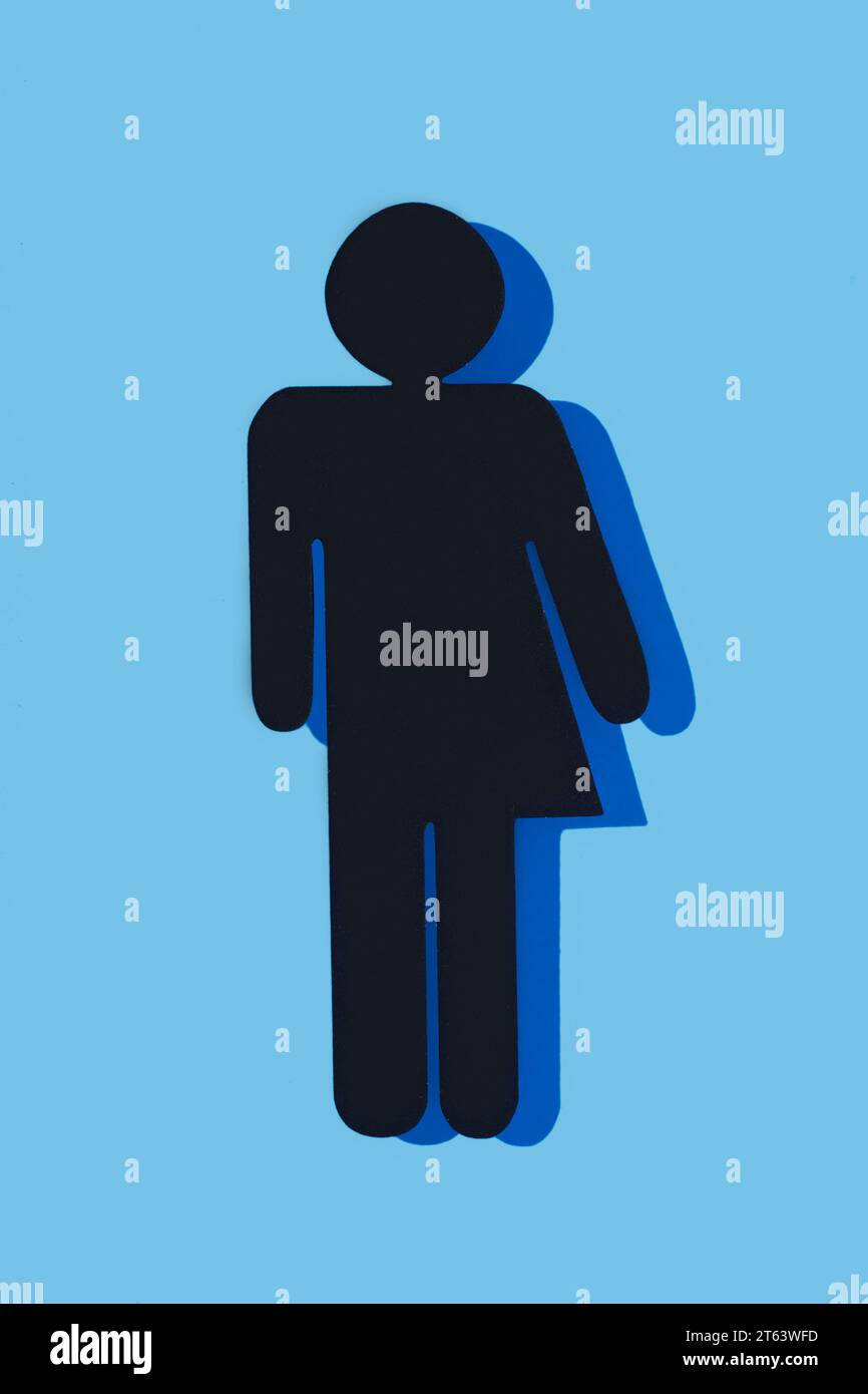 closeup of a black gender neutral icon, with a dark blue shadow, on a blue background Stock Photo