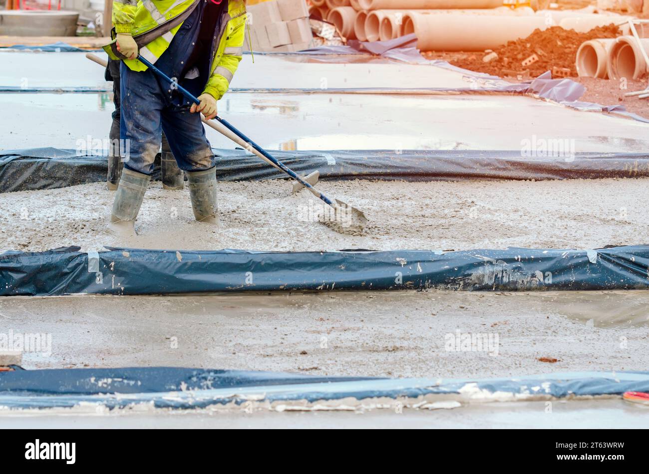 Builder pouring ground floor slab of a new house with wet readymix