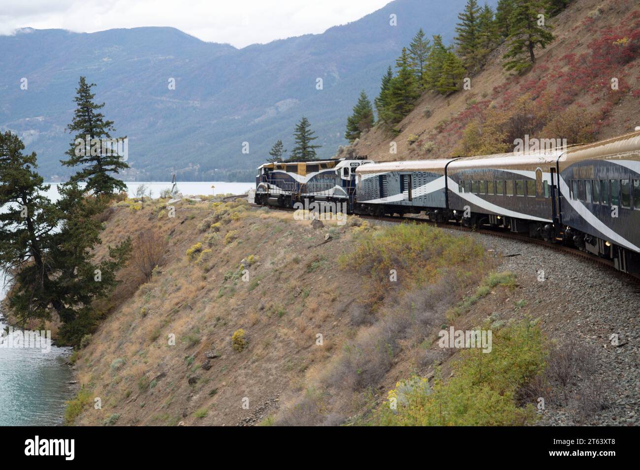 Rocky Mountaineer Train running along a lake side, British Columbia, Canada Stock Photo