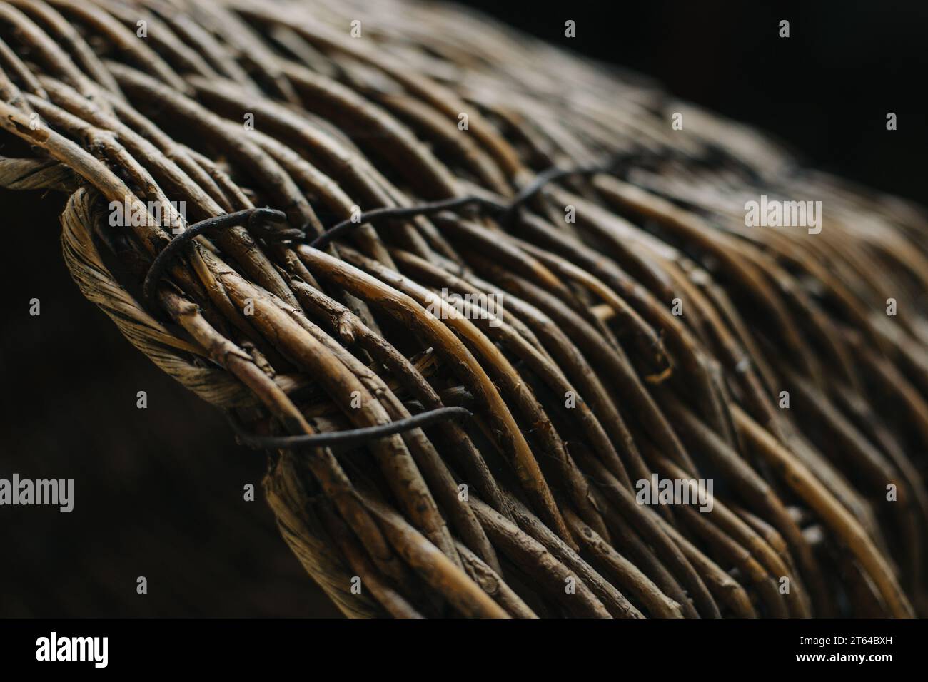 Texture of wicker basket on a dark background. Close-up. Selective focus. Stock Photo