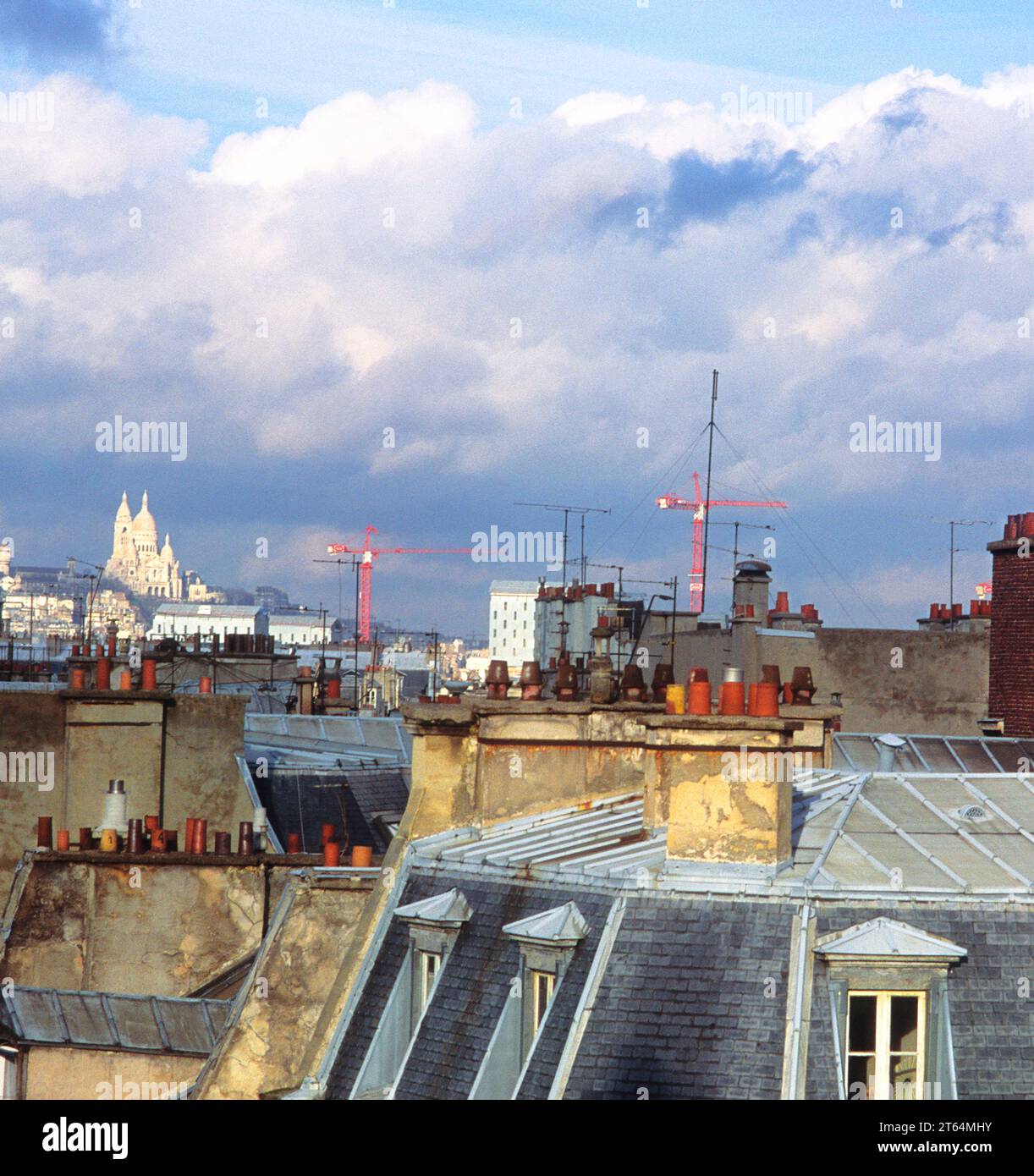 Sacre Coeur Basilica Montmartre, Paris. Distant view of the cathedral and rooftops of buildings. Scenic from window on the Left Bank. France, Europe Stock Photo