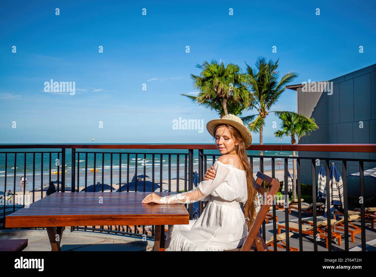 Captured moment of woman observing seascape from terrace Stock Photo