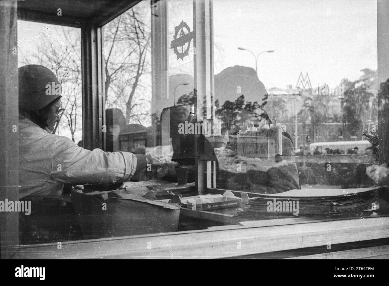 Moscow, USSR - Circa 1982: Seller in ice cream kiosk by Shchukinskaya metro station. Black and white film scan Stock Photo