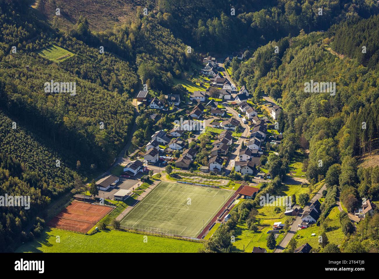 Aerial view, residential area Glingestraße and sports field, hilly landscape and wooded area, Rönkhausen, Finnentrop, Sauerland, North Rhine-Westphali Stock Photo