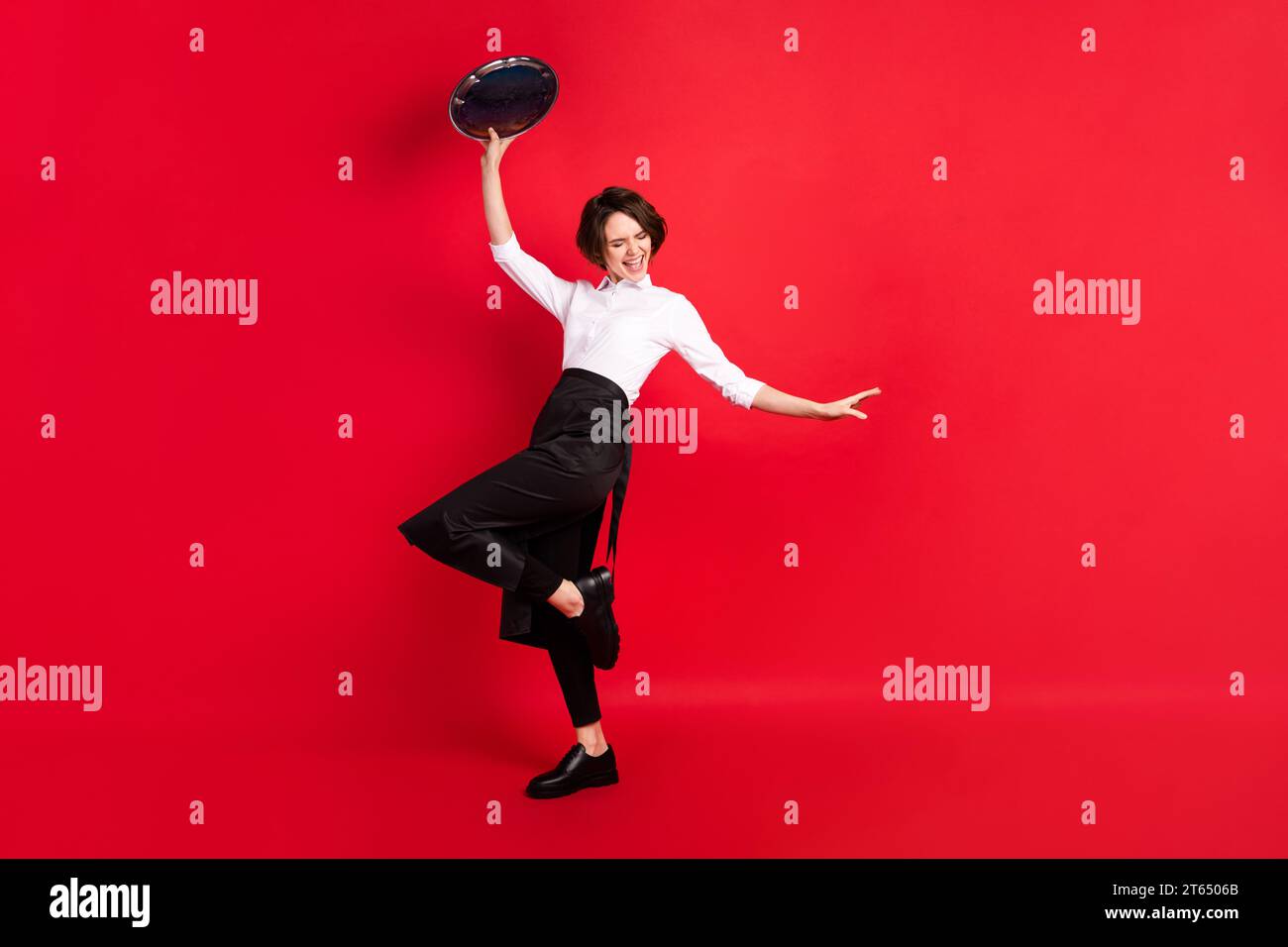 Full body photo of cheerful positive young woman raise tray dance ...