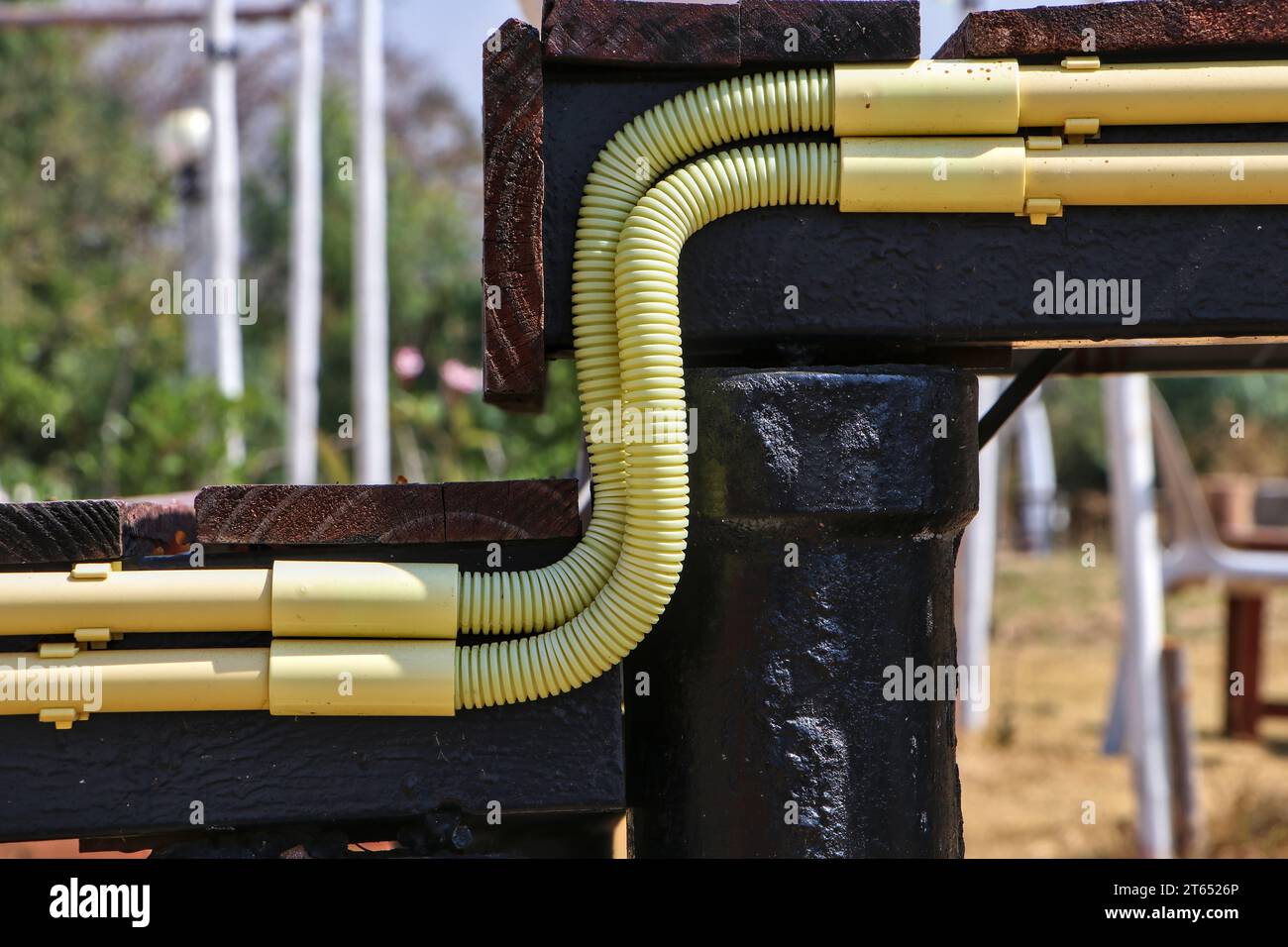 Close-up of yellow PVC pipes arranged by an electrician in a nice and harmonious way. Stock Photo