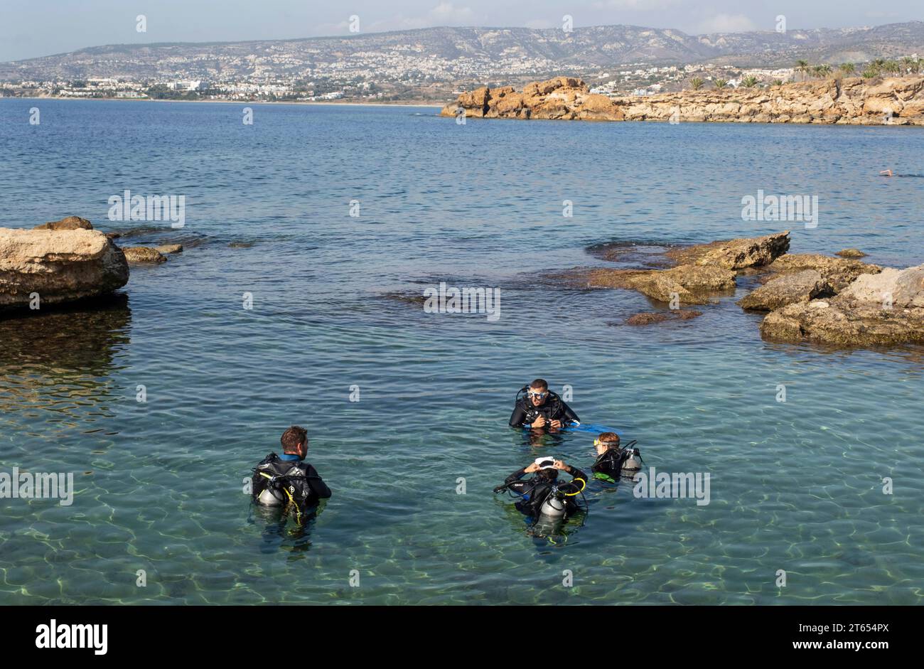 Diving instructor giving lessons to novice divers, Paphos, Cyprus Stock Photo