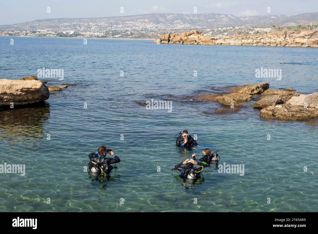 Diving instructor giving lessons to novice divers, Paphos, Cyprus Stock Photo