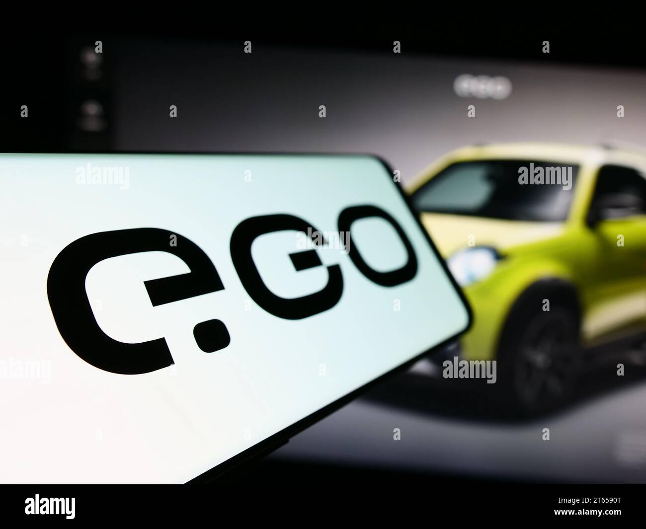 Cellphone with logo of German electric vehicle company Next.e.GO Mobile SE in front of business website. Focus on left of phone display. Stock Photo