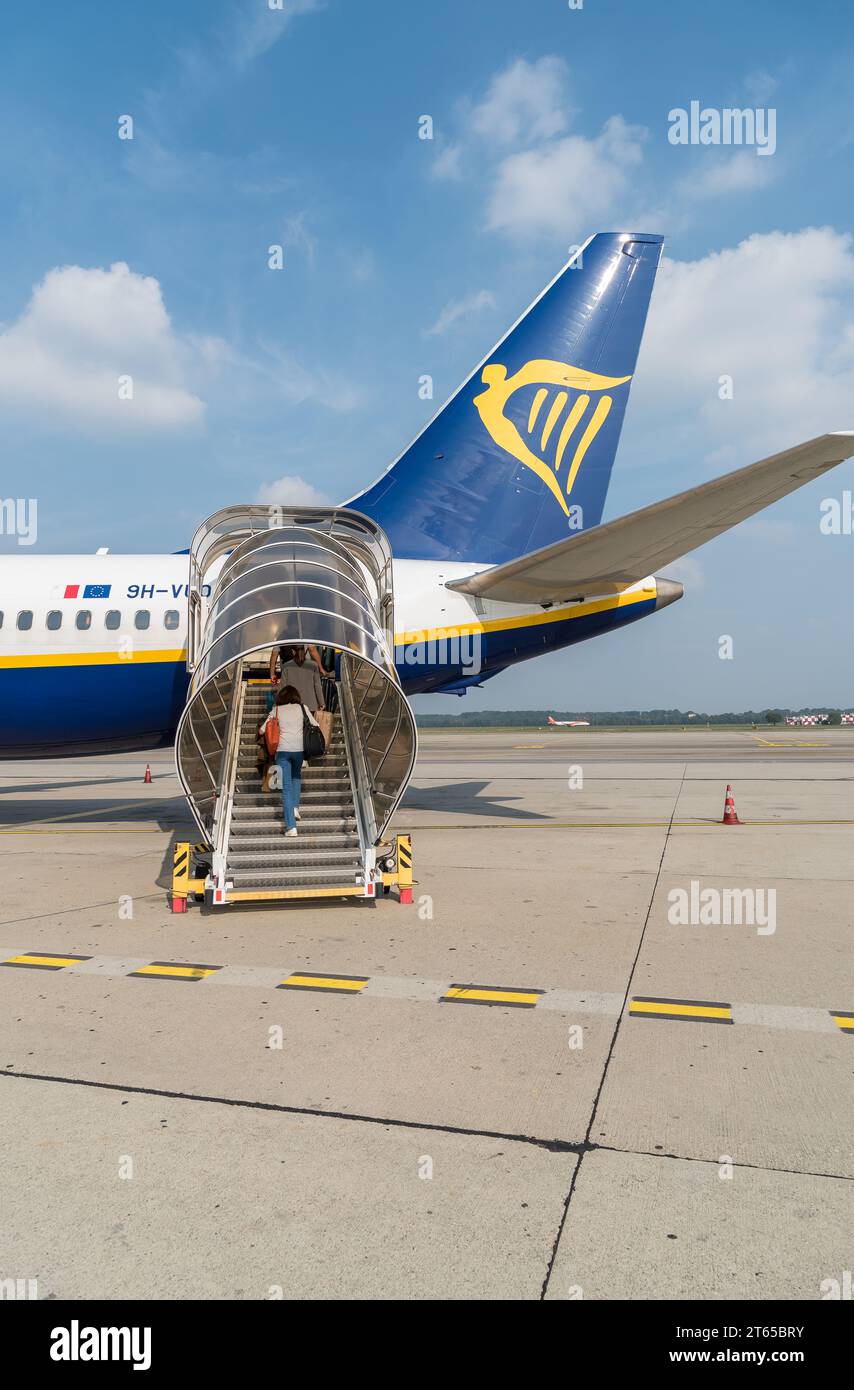 Ferno, Milan-Malpensa, Italy - October 3, 2023: Passengers boarding at low cost airline company Ryanair in the Milan-Malpensa international airport Te Stock Photo