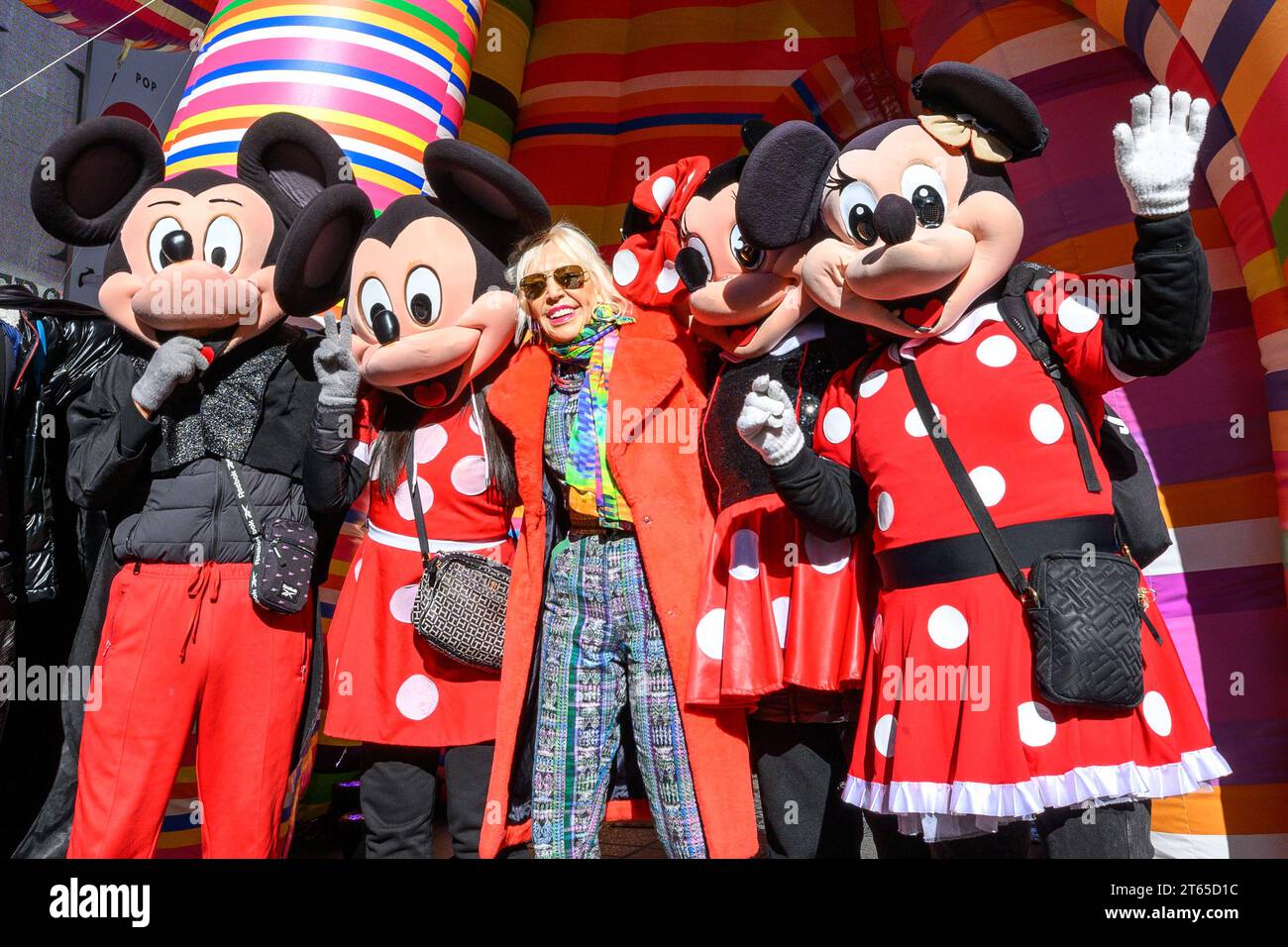 New York, USA. , . Argentinian conceptual pop artist Marta Minujín, 80, poses next to her "Sculpture of Dreams" installation in Times Square along with characters representing Mickey and Minnie Mouse. The vibrant, large-scale, 16-piece inflatable in the artist's signature stripes is Minujín's first public sculpture in New York City in her sixty-year career, and is presented to coincide with the Jewish Museum's major survey exhibition of her work, Marta Minujín: Arte! Arte! Arte!, opening on November 17. Credit: Enrique Shore/Alamy Live News Stock Photo