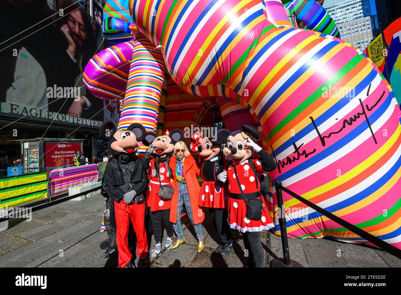 New York, USA. , . Argentinian conceptual pop artist Marta Minujín, 80, poses next to her 'Sculpture of Dreams' installation in Times Square along with characters representing Mickey and Minnie Mouse. The vibrant, large-scale, 16-piece inflatable in the artist's signature stripes is Minujín's first public sculpture in New York City in her sixty-year career, and is presented to coincide with the Jewish Museum's major survey exhibition of her work, Marta Minujín: Arte! Arte! Arte!, opening on November 17. Credit: Enrique Shore/Alamy Live News Stock Photo