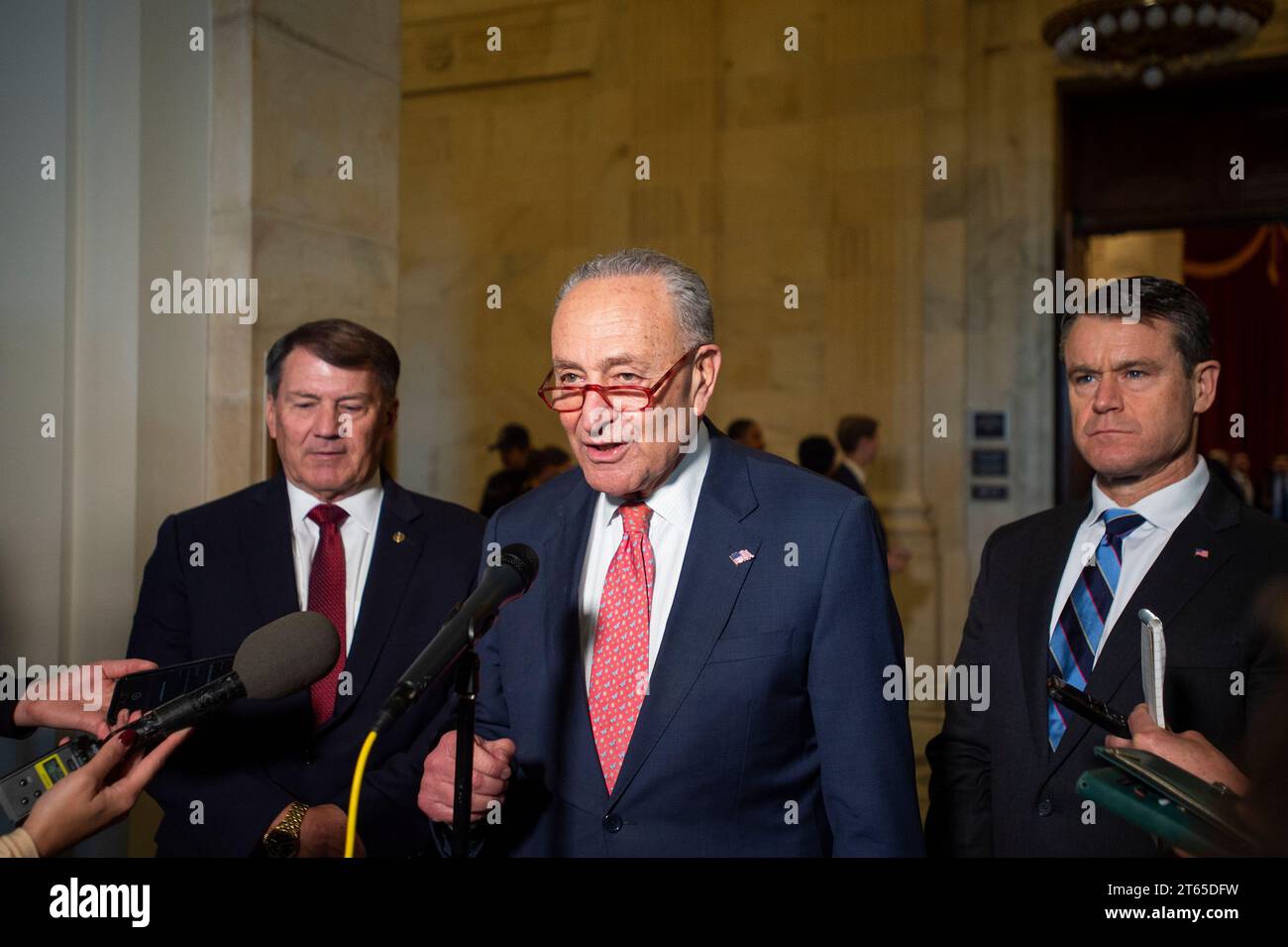 United States Senate Majority Leader Chuck Schumer (Democrat of New York), center, is joined by United States Senator Mike Rounds (Republican of South Dakota), left, and United States Senator Todd Young (Republican of Indiana) for a press briefing in between panels of the Senate bipartisan AI Insight Forums in the Russell Senate Office Building in Washington, DC, Wednesday, November 8, 2023. The AI Insight Forums seek to bring together AI stakeholders to supercharge the Congressional process to develop bipartisan artificial intelligence legislation. The Forums have focused on capitalizing on t Stock Photo