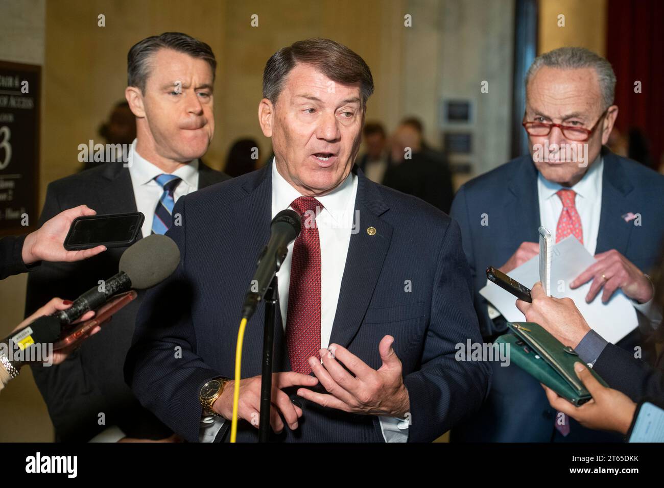 United States Senator Mike Rounds (Republican of South Dakota), center, is joined by United States Senator Todd Young (Republican of Indiana), left, and United States Senate Majority Leader Chuck Schumer (Democrat of New York), right, for a press briefing in between panels of the Senate bipartisan AI Insight Forums in the Russell Senate Office Building in Washington, DC, Wednesday, November 8, 2023. The AI Insight Forums seek to bring together AI stakeholders to supercharge the Congressional process to develop bipartisan artificial intelligence legislation. The Forums have focused on capitaliz Stock Photo