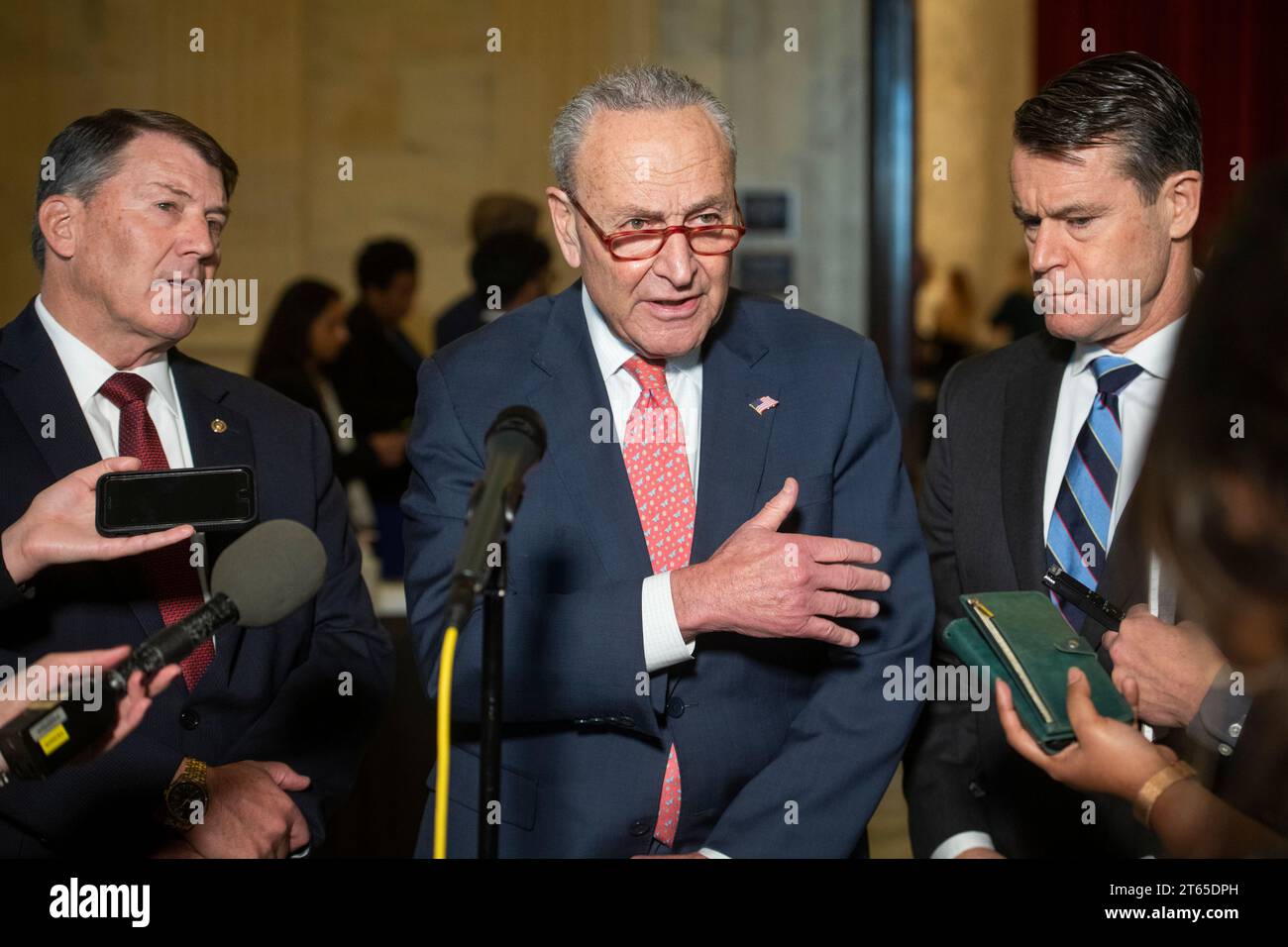 United States Senate Majority Leader Chuck Schumer (Democrat of New York), center, is joined by United States Senator Mike Rounds (Republican of South Dakota), left, and United States Senator Todd Young (Republican of Indiana) for a press briefing in between panels of the Senate bipartisan AI Insight Forums in the Russell Senate Office Building in Washington, DC, Wednesday, November 8, 2023. The AI Insight Forums seek to bring together AI stakeholders to supercharge the Congressional process to develop bipartisan artificial intelligence legislation. The Forums have focused on capitalizing on t Stock Photo