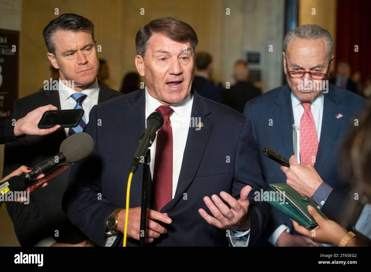 United States Senator Mike Rounds Republican of South Dakota, center, is joined by United States Senator Todd Young Republican of Indiana, left, and United States Senate Majority Leader Chuck Schumer Democrat of New York, right, for a press briefing in between panels of the Senate bipartisan AI Insight Forums in the Russell Senate Office Building in Washington, DC, Wednesday, November 8, 2023. The AI Insight Forums seek to bring together AI stakeholders to supercharge the Congressional process to develop bipartisan artificial intelligence legislation. The Forums have focused on capitalizing on Stock Photo