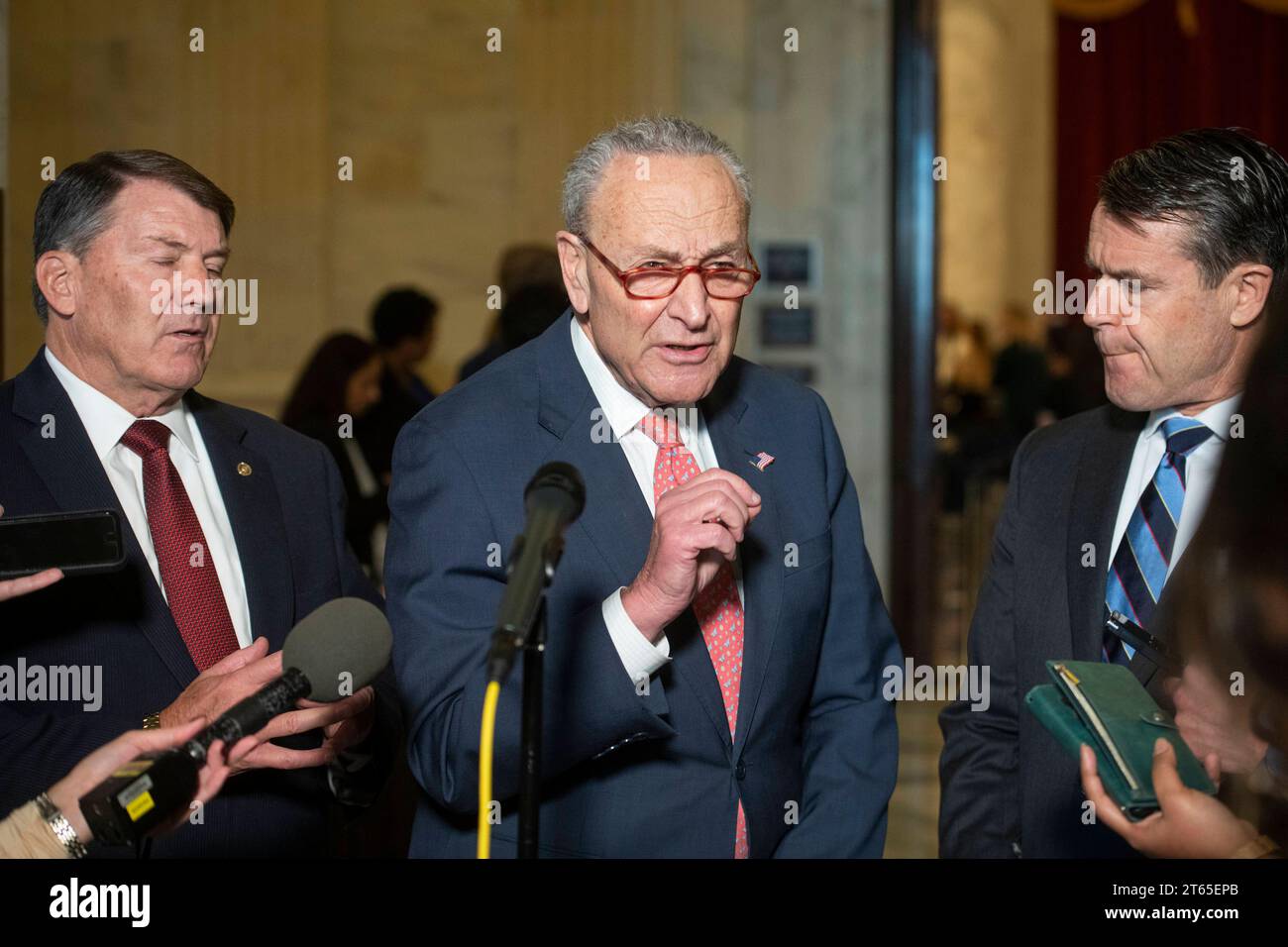 United States Senate Majority Leader Chuck Schumer Democrat of New York, center, is joined by United States Senator Mike Rounds Republican of South Dakota, left, and United States Senator Todd Young Republican of Indiana for a press briefing in between panels of the Senate bipartisan AI Insight Forums in the Russell Senate Office Building in Washington, DC, Wednesday, November 8, 2023. The AI Insight Forums seek to bring together AI stakeholders to supercharge the Congressional process to develop bipartisan artificial intelligence legislation. The Forums have focused on capitalizing on the opp Stock Photo