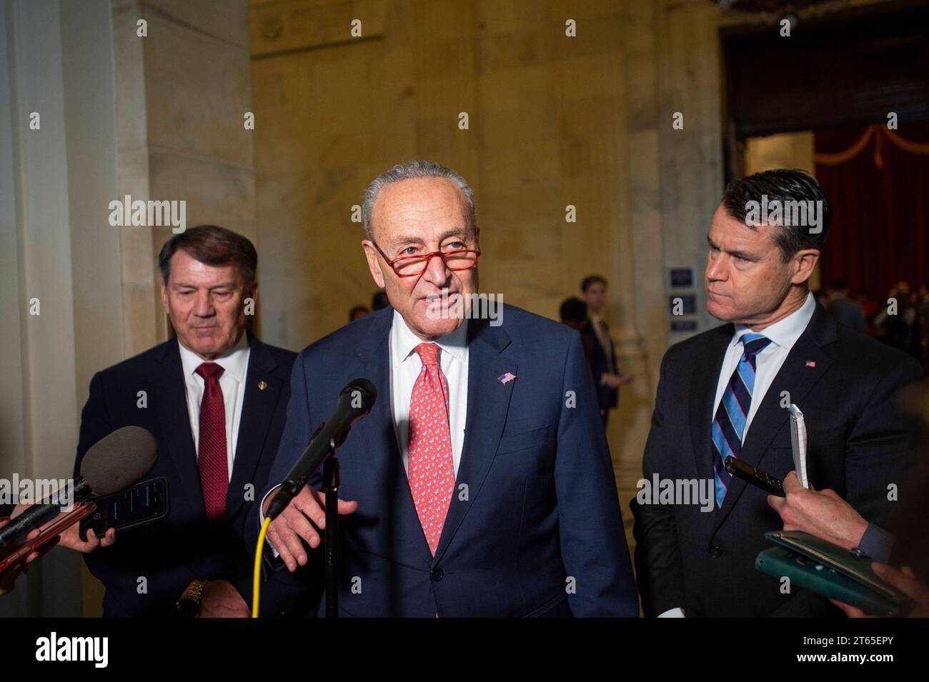 United States Senate Majority Leader Chuck Schumer Democrat of New York, center, is joined by United States Senator Mike Rounds Republican of South Dakota, left, and United States Senator Todd Young Republican of Indiana for a press briefing in between panels of the Senate bipartisan AI Insight Forums in the Russell Senate Office Building in Washington, DC, Wednesday, November 8, 2023. The AI Insight Forums seek to bring together AI stakeholders to supercharge the Congressional process to develop bipartisan artificial intelligence legislation. The Forums have focused on capitalizing on the opp Stock Photo