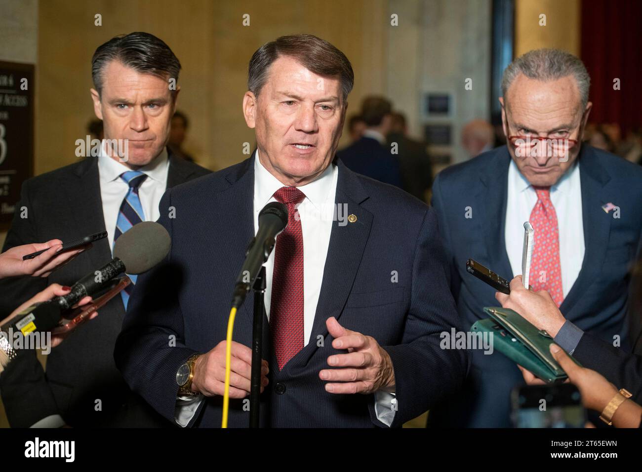 United States Senator Mike Rounds Republican of South Dakota, center, is joined by United States Senator Todd Young Republican of Indiana, left, and United States Senate Majority Leader Chuck Schumer Democrat of New York, right, for a press briefing in between panels of the Senate bipartisan AI Insight Forums in the Russell Senate Office Building in Washington, DC, Wednesday, November 8, 2023. The AI Insight Forums seek to bring together AI stakeholders to supercharge the Congressional process to develop bipartisan artificial intelligence legislation. The Forums have focused on capitalizing on Stock Photo