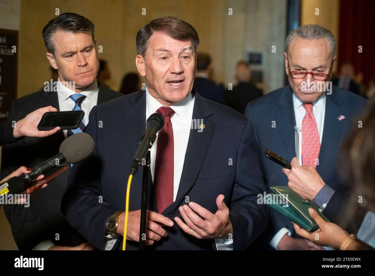 United States Senator Mike Rounds Republican of South Dakota, center, is joined by United States Senator Todd Young Republican of Indiana, left, and United States Senate Majority Leader Chuck Schumer Democrat of New York, right, for a press briefing in between panels of the Senate bipartisan AI Insight Forums in the Russell Senate Office Building in Washington, DC, Wednesday, November 8, 2023. The AI Insight Forums seek to bring together AI stakeholders to supercharge the Congressional process to develop bipartisan artificial intelligence legislation. The Forums have focused on capitalizing on Stock Photo