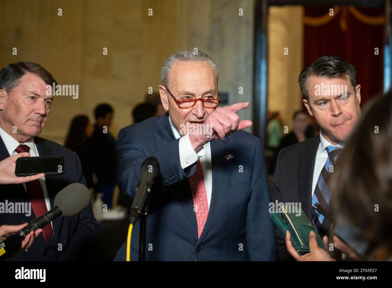 United States Senate Majority Leader Chuck Schumer (Democrat of New York), center, is joined by United States Senator Mike Rounds (Republican of South Dakota), left, and United States Senator Todd Young (Republican of Indiana) for a press briefing in between panels of the Senate bipartisan AI Insight Forums in the Russell Senate Office Building in Washington, DC, Wednesday, November 8, 2023. The AI Insight Forums seek to bring together AI stakeholders to supercharge the Congressional process to develop bipartisan artificial intelligence legislation. The Forums have focused on capitalizing on t Stock Photo