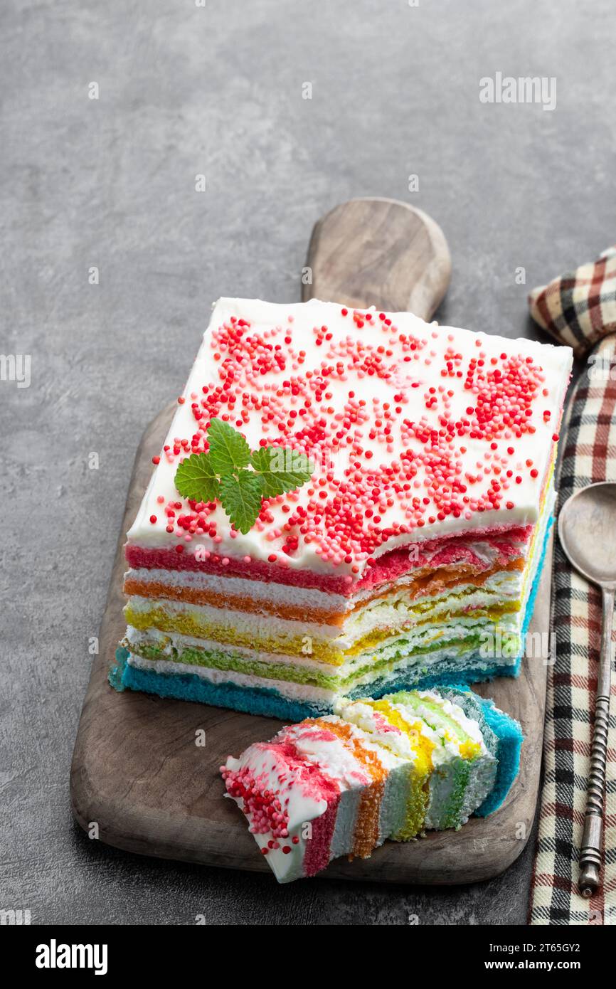 Multicolored  rainbow cake on gray background Stock Photo