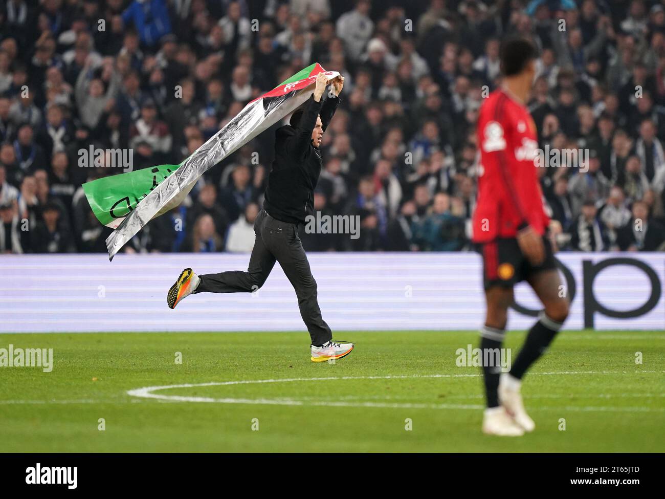 A pitch invader waves a Palestine flag during the UEFA Champions League Group A match at the Parken Stadium, Copenhagen. Picture date: Wednesday November 8, 2023. Stock Photo