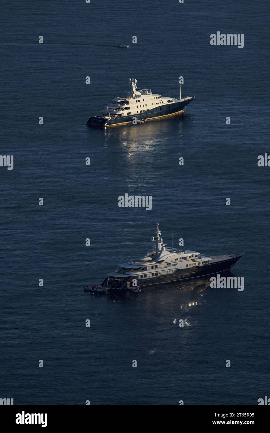 Monaco, two mega yachts are in sea at sunset, huge motor boats, wealth ...