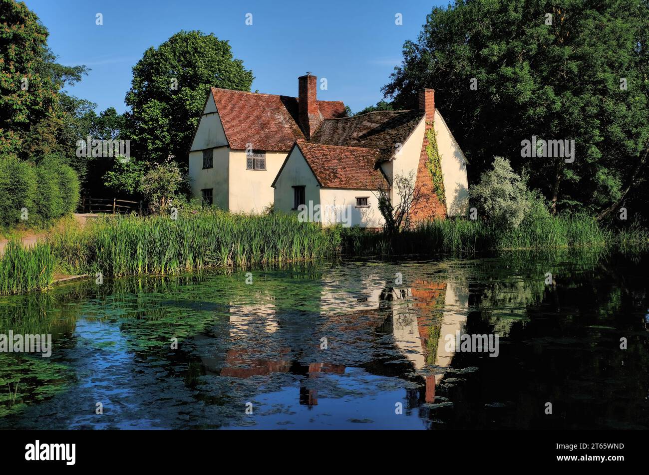 Willy Lott's House (in Hay Wain) with reflections in River Stour, Flatford village, John Constable Country, Dedham Vale, Suffolk, England, UK Stock Photo