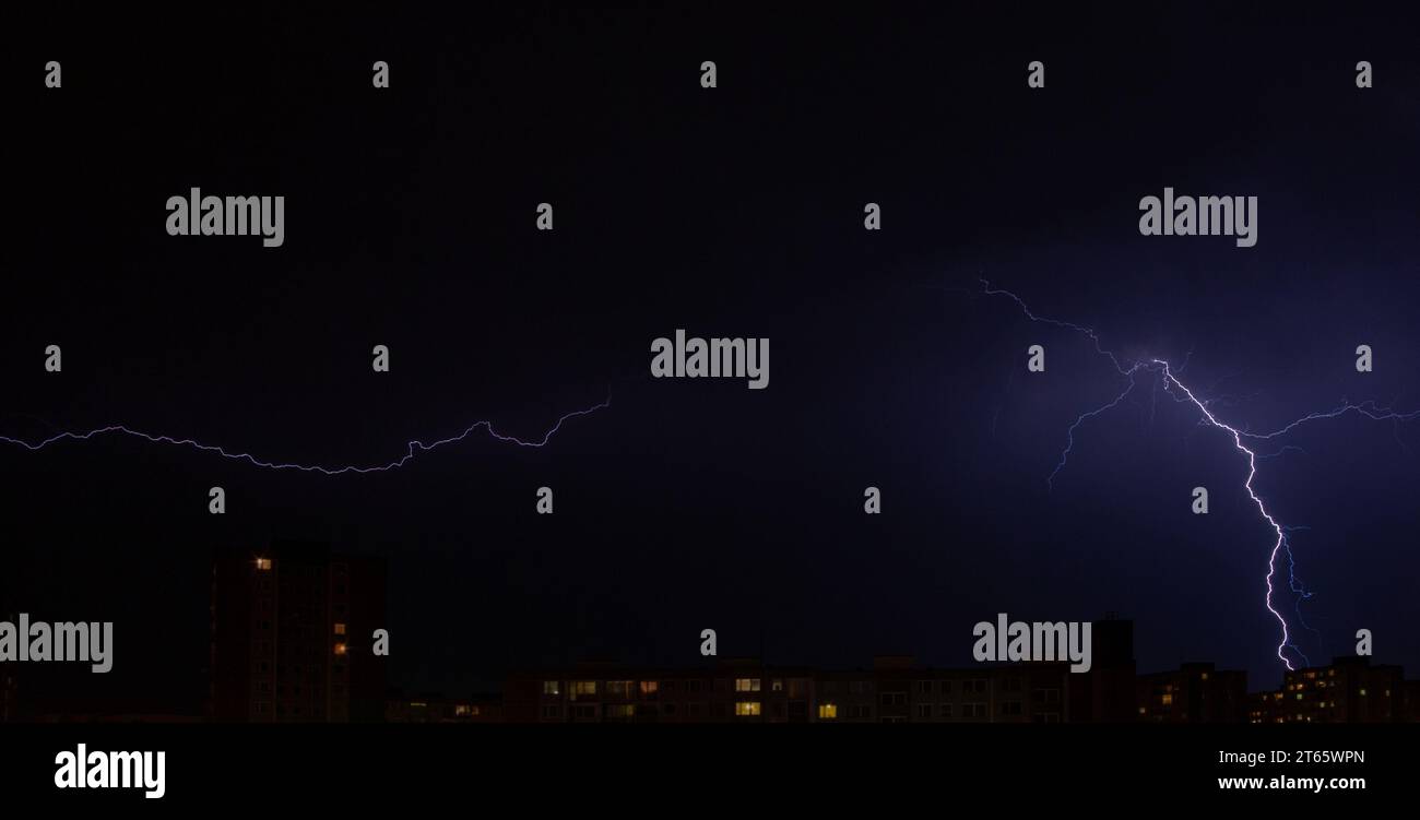 night lightning bolts, bolts over the city, dramatic scene on the night sky Stock Photo