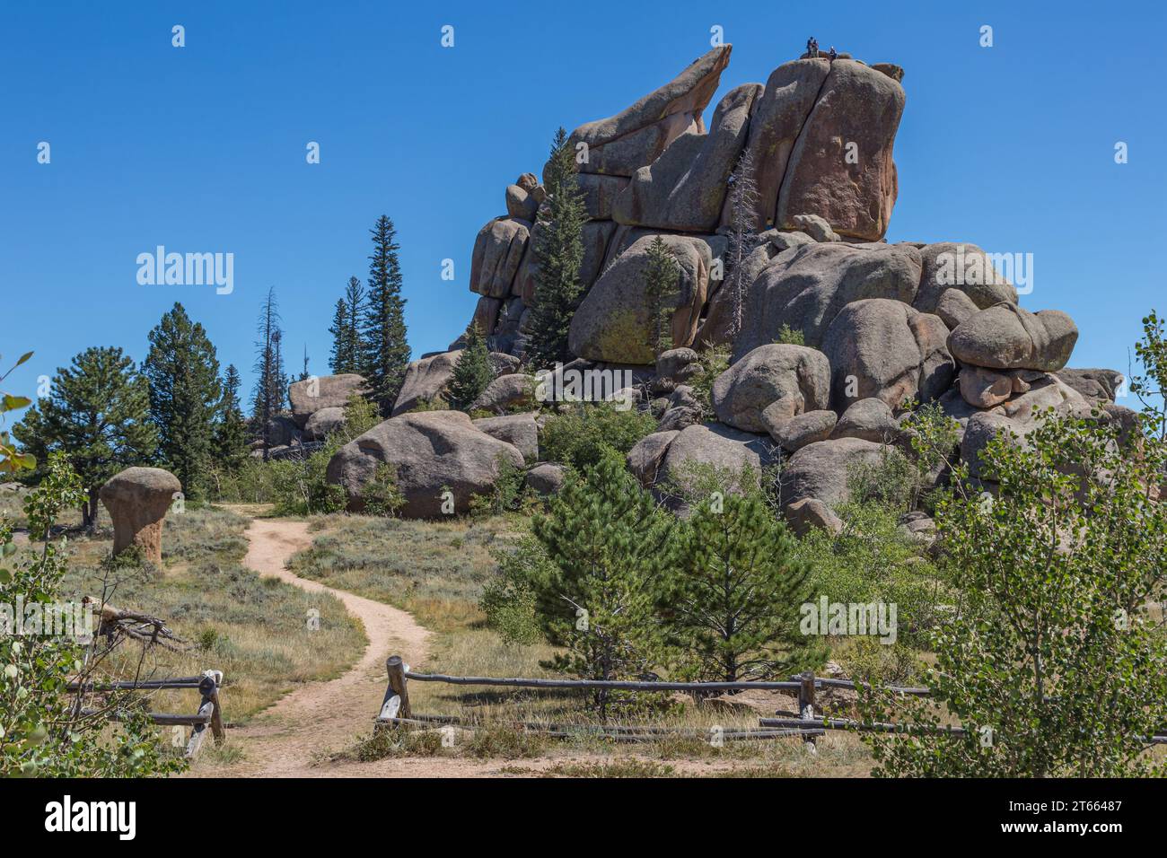 Men rock climbing on a large granite boulder in the Vedauwoo Recreation