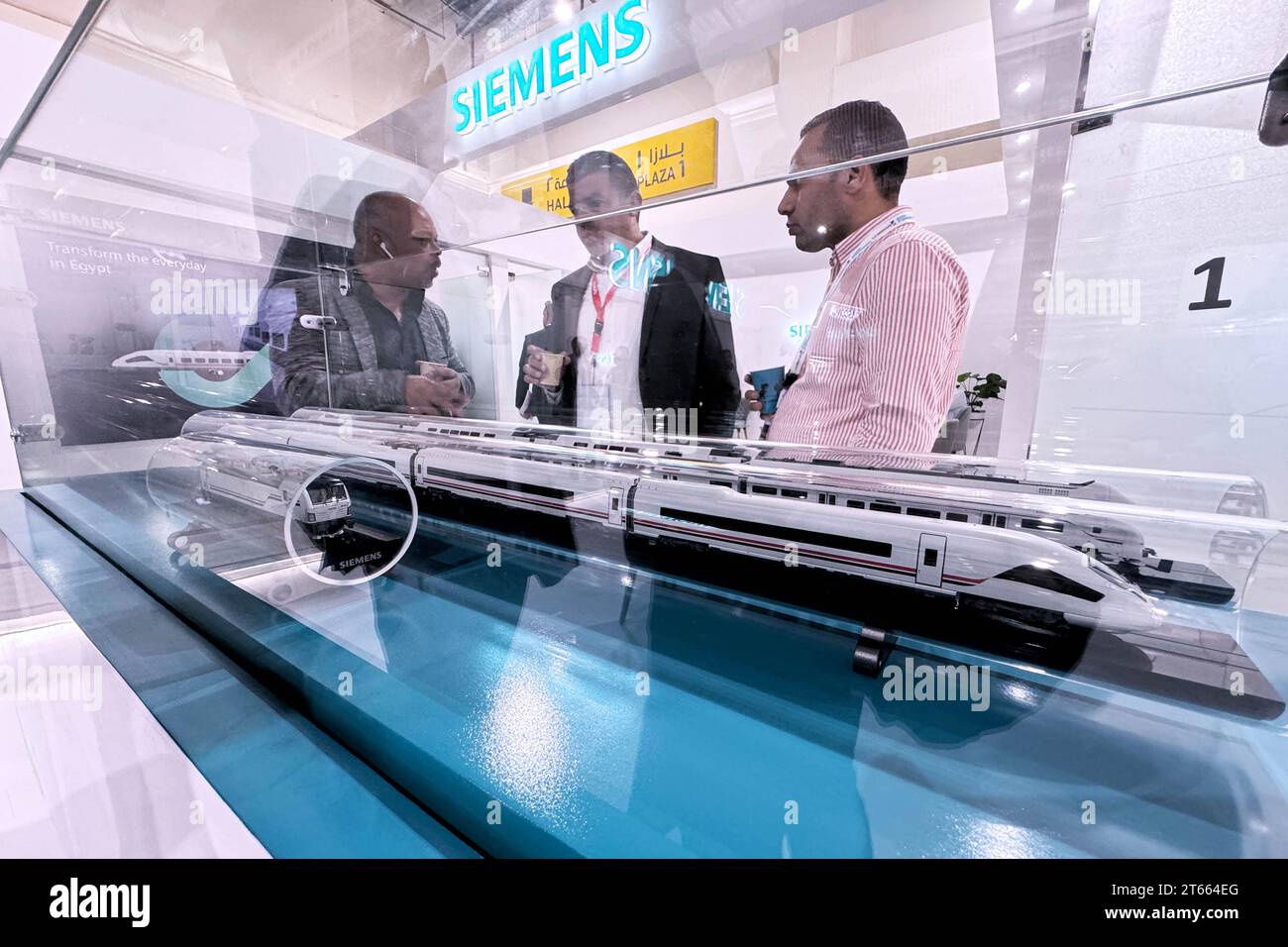 (231108) -- CAIRO, Nov. 8, 2023 (Xinhua) -- People talk in front of train models during the Smart Transport, Logistics, Infrastructure, and Traffic Fair for the Middle East and Africa in Cairo, Egypt, on Nov. 7, 2023. Egypt's international transportation exhibition has witnessed enthusiastic participation from Chinese companies, which are eager to take part in the transport development in the Middle East, especially in Egypt. The fifth Smart Transport, Logistics, Infrastructure, and Traffic Fair and Forum for the Middle East and Africa was held in New Cairo from Nov. 5 to 8 with the sponsor of Stock Photo