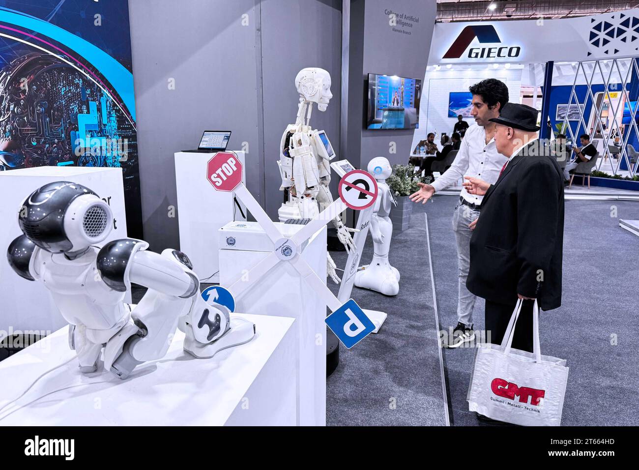 (231108) -- CAIRO, Nov. 8, 2023 (Xinhua) -- People view robots during the Smart Transport, Logistics, Infrastructure, and Traffic Fair for the Middle East and Africa in Cairo, Egypt, on Nov. 7, 2023. Egypt's international transportation exhibition has witnessed enthusiastic participation from Chinese companies, which are eager to take part in the transport development in the Middle East, especially in Egypt. The fifth Smart Transport, Logistics, Infrastructure, and Traffic Fair and Forum for the Middle East and Africa was held in New Cairo from Nov. 5 to 8 with the sponsor of Egypt's Ministry Stock Photo