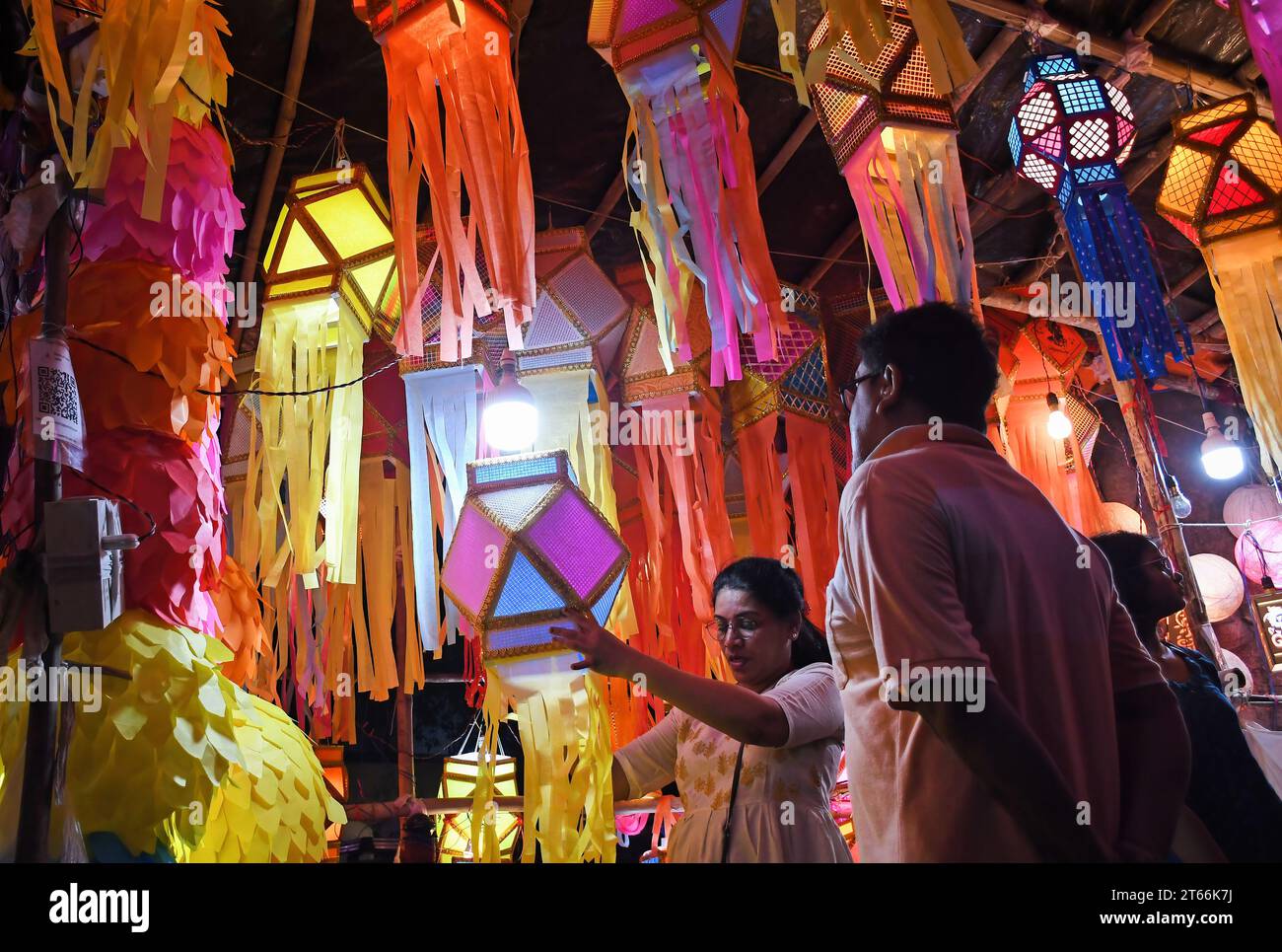 Mumbai, India. 08th Nov, 2023. A woman (shopkeeper) arranges small lanterns for sale ahead of Diwali festival in Mumbai. Diwali festival is celebrated by Hindus where they shop for lanterns ahead of the festival, clean their home, prepare sweets and snacks, make rangoli (traditional Indian art form where various designs are made on the floor) and light their homes with earthen lamps marking victory of light over darkness. Credit: SOPA Images Limited/Alamy Live News Stock Photo