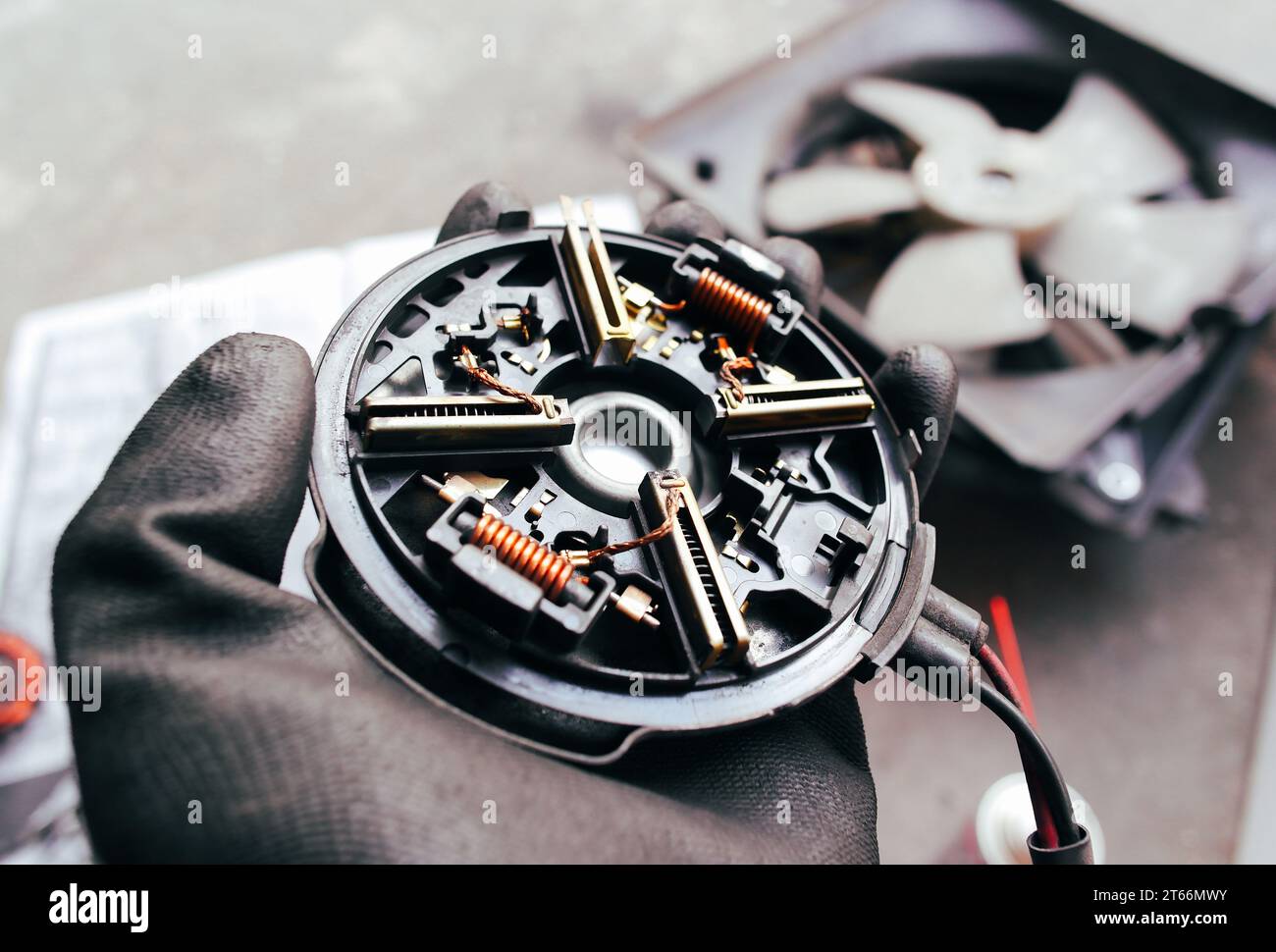 Close up of carbon brush cover of fan electric motor of car radiator