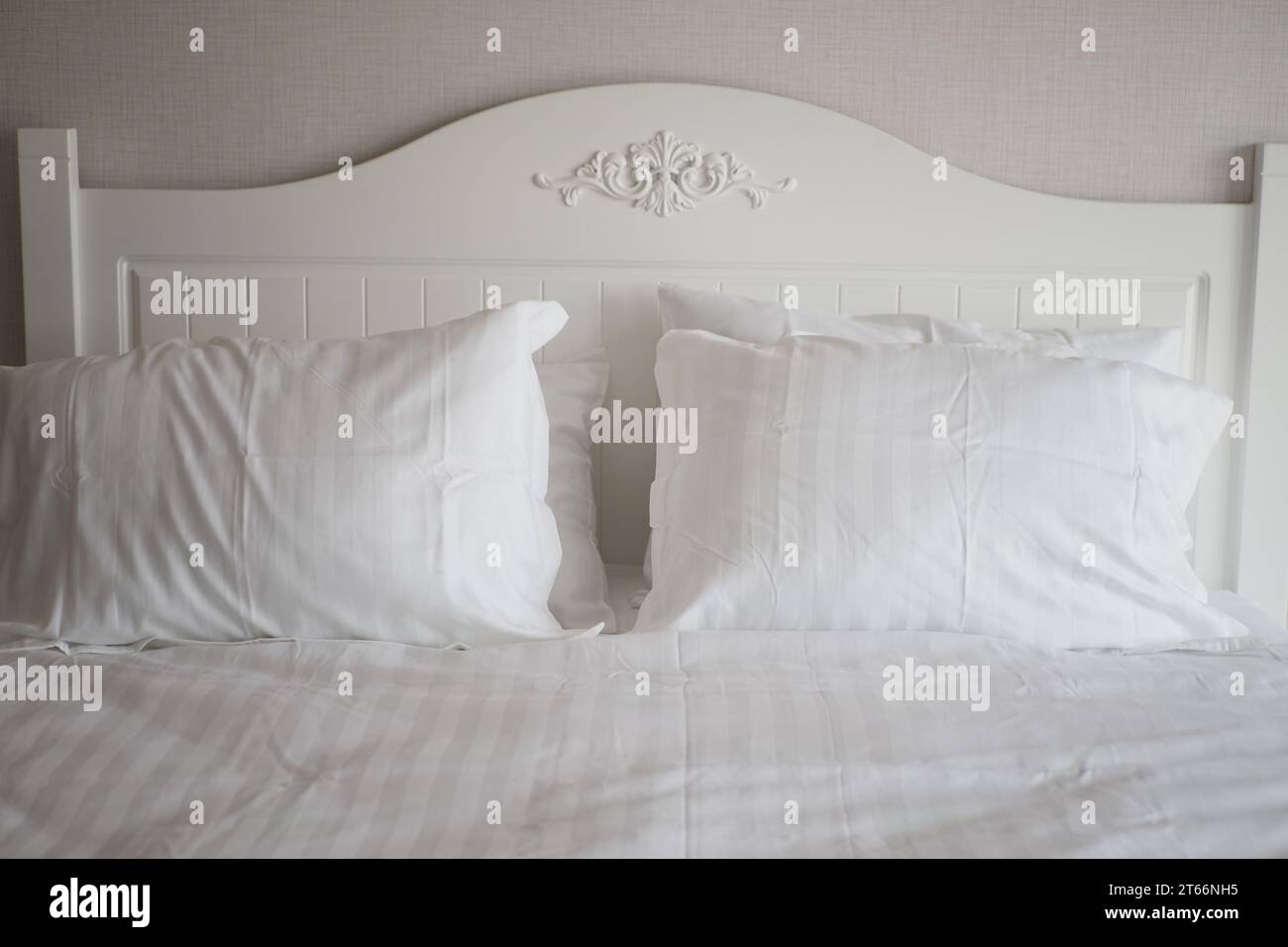 white pillow lined up on bed Stock Photo