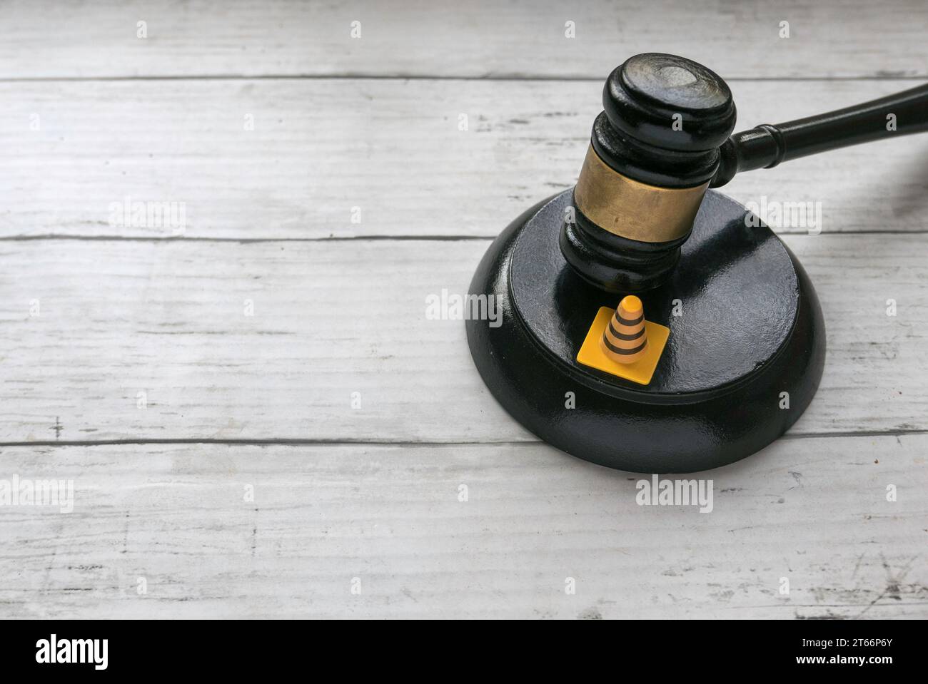 Traffic cone and gavel over a wooden background. Stock Photo