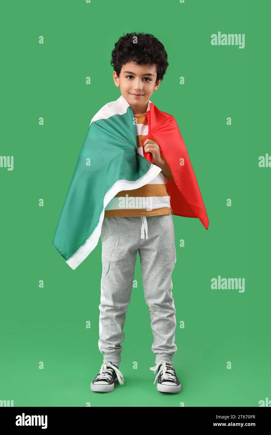 Little boy with Mexican flag on green background Stock Photo