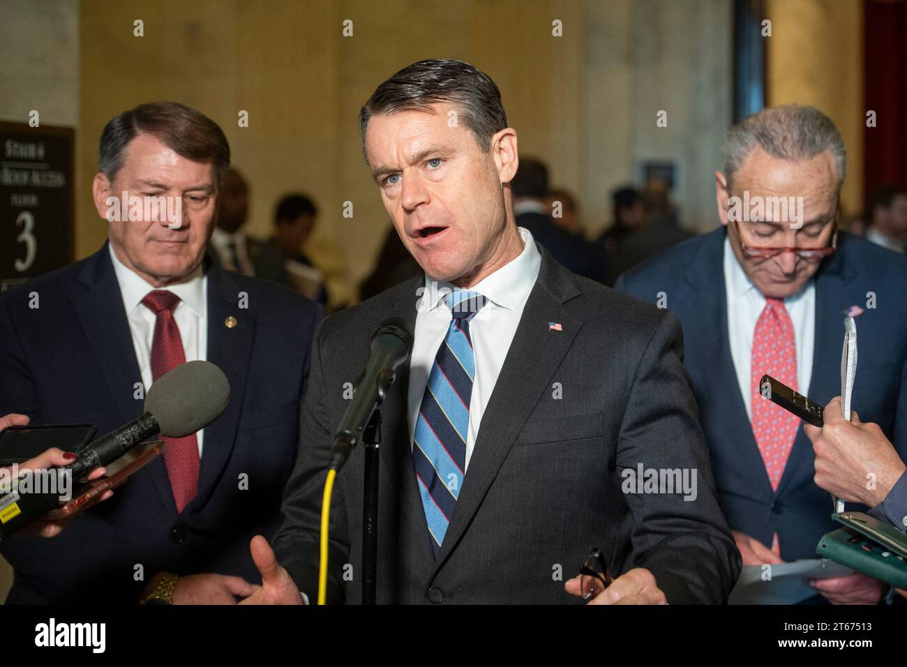 United States Senator Todd Young (Republican of Indiana), center, is joined by United States Senator Mike Rounds (Republican of South Dakota), left, and United States Senate Majority Leader Chuck Schumer (Democrat of New York), right, for a press briefing in between panels of the Senate bipartisan AI Insight Forums in the Russell Senate Office Building in Washington, DC, USA, Wednesday, November 8, 2023. The AI Insight Forums seek to bring together AI stakeholders to supercharge the Congressional process to develop bipartisan artificial intelligence legislation. The Forums have focused on capi Stock Photo