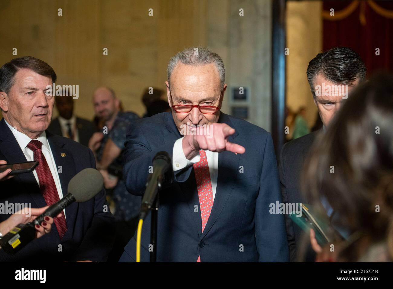 United States Senate Majority Leader Chuck Schumer (Democrat of New York), center, is joined by United States Senator Mike Rounds (Republican of South Dakota), left, and United States Senator Todd Young (Republican of Indiana) for a press briefing in between panels of the Senate bipartisan AI Insight Forums in the Russell Senate Office Building in Washington, DC, USA, Wednesday, November 8, 2023. The AI Insight Forums seek to bring together AI stakeholders to supercharge the Congressional process to develop bipartisan artificial intelligence legislation. The Forums have focused on capitalizing Stock Photo