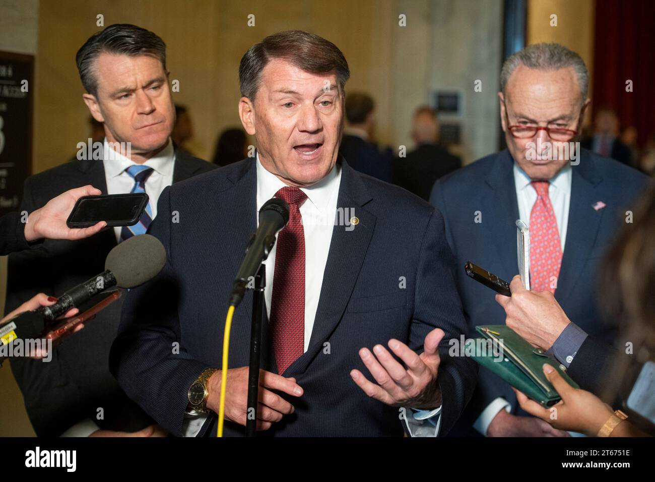 United States Senator Mike Rounds (Republican of South Dakota), center, is joined by United States Senator Todd Young (Republican of Indiana), left, and United States Senate Majority Leader Chuck Schumer (Democrat of New York), right, for a press briefing in between panels of the Senate bipartisan AI Insight Forums in the Russell Senate Office Building in Washington, DC, USA, Wednesday, November 8, 2023. The AI Insight Forums seek to bring together AI stakeholders to supercharge the Congressional process to develop bipartisan artificial intelligence legislation. The Forums have focused on capi Stock Photo