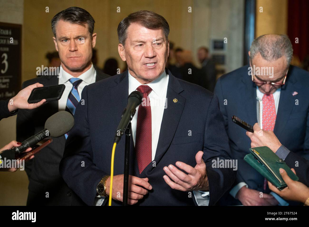 United States Senator Mike Rounds (Republican of South Dakota), center, is joined by United States Senator Todd Young (Republican of Indiana), left, and United States Senate Majority Leader Chuck Schumer (Democrat of New York), right, for a press briefing in between panels of the Senate bipartisan AI Insight Forums in the Russell Senate Office Building in Washington, DC, USA, Wednesday, November 8, 2023. The AI Insight Forums seek to bring together AI stakeholders to supercharge the Congressional process to develop bipartisan artificial intelligence legislation. The Forums have focused on capi Stock Photo