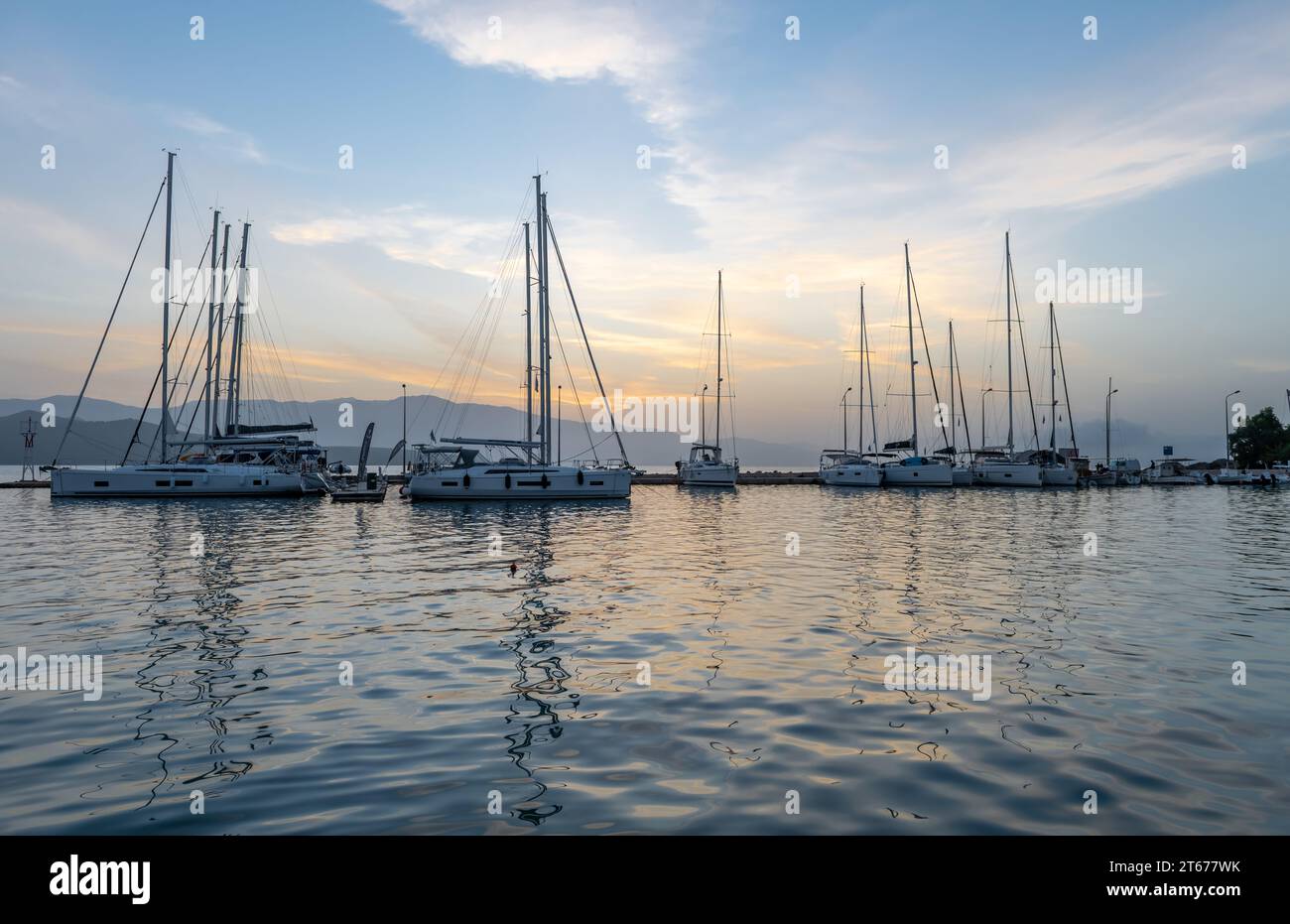 Sunrise sky clouds and reflections. Nikiana harbour. Lefkada. Greece. Stock Photo
